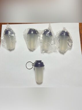 1 Tupperware Mini Shaker Bottle Keychain. Approximately 2 1/2 inches tall.